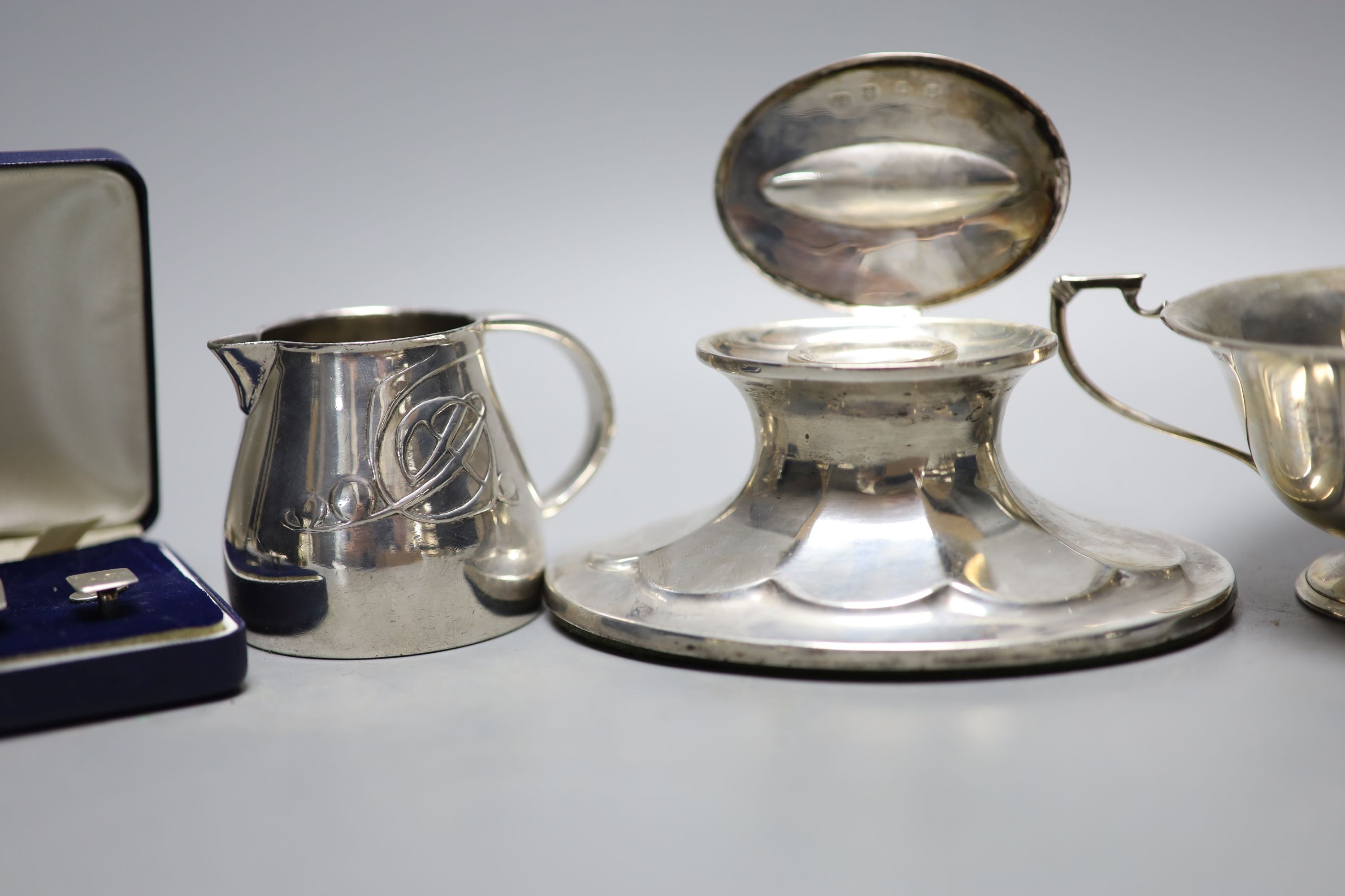 A Scottish silver mounted oval inkwell, 13.2cm, a small silver bowl, silver vesta case, silver cigarette case, two silver napkin rings and two other items.